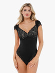 Black lace deep V bodysuit with cap sleeves, shaping the figure.