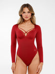 Red long-sleeve shapewear bodysuit with criss-cross mesh bust detail and tummy control