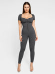 Women's gray denim jumpsuit with zip front, designed by Popilush®, offering a flattering fit with built-in shapewear.