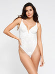 White lace hourglass thong bodysuit, deep V-neck, low back shapewear.