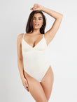 White modal sculpting thong bodysuit with deep V-neck and adjustable straps.
