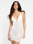 Women's white lace deep V-neck shapewear bodysuit with tummy control, mid-thigh.