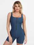 Blue sculpting shapewear romper with imitation denim, square neck, and front zipper.