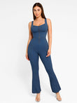 Blue denim sculpting tank flare leg jumpsuit with square neck and front zipper.