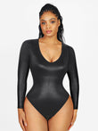 Shiny black long sleeve faux leather sculpting bodysuit with deep V-neck.
