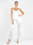 White metallic shine sculpting jumpsuit with corset bodice, wide straps, flare legs.