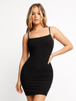Black ribbed mini slip dress with adjustable spaghetti straps on a woman.