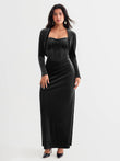 Black velvet long-sleeve shrug bolero layered over a matching corset dress.
