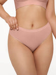 Seamless solid mid-rise thong brief in nude pink.