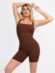 Model in brown seamless square neck ribbed one piece sport romper with mid-thigh leg length.