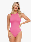 Woman in pink bodysuit from Popilush®, sleeveless shapewear with flattering fit.