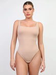 Seamless nude CloudSense shapewear tank top bodysuit with high-cut thong.