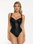 Black faux leather hourglass corset bodysuit, sculpting V-neck with wide straps.