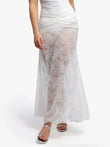 White lace fishtail maxi skirt with ruched waist, elegant floral pattern and silver sandals.