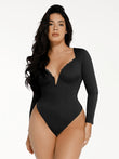 Black long sleeve shapewear bodysuit with V-neck, lace trim, and slimming fit.