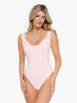 Model in pink Popilush® shapewear bodysuit. Tummy control and a smooth design are highlighted.