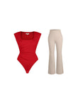Red padded shoulder slimming bodysuit with ruched waist and beige flare-leg pants set.
