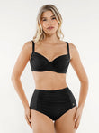 Woman wearing a black ruched tummy control bikini set with a built-in underwire top and high-waisted bottoms.