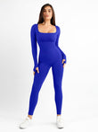 Royal blue ribbed shapewear jumpsuit with square neck and thumbholes, worn with white sneakers.