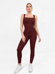 Shapewear seamless square neck workout jumpsuit, body-con fit, ribbed burgundy fabric, on model.