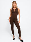 Brown sleeveless body-sculpting zip front shapewear jumpsuit with compression and pockets.