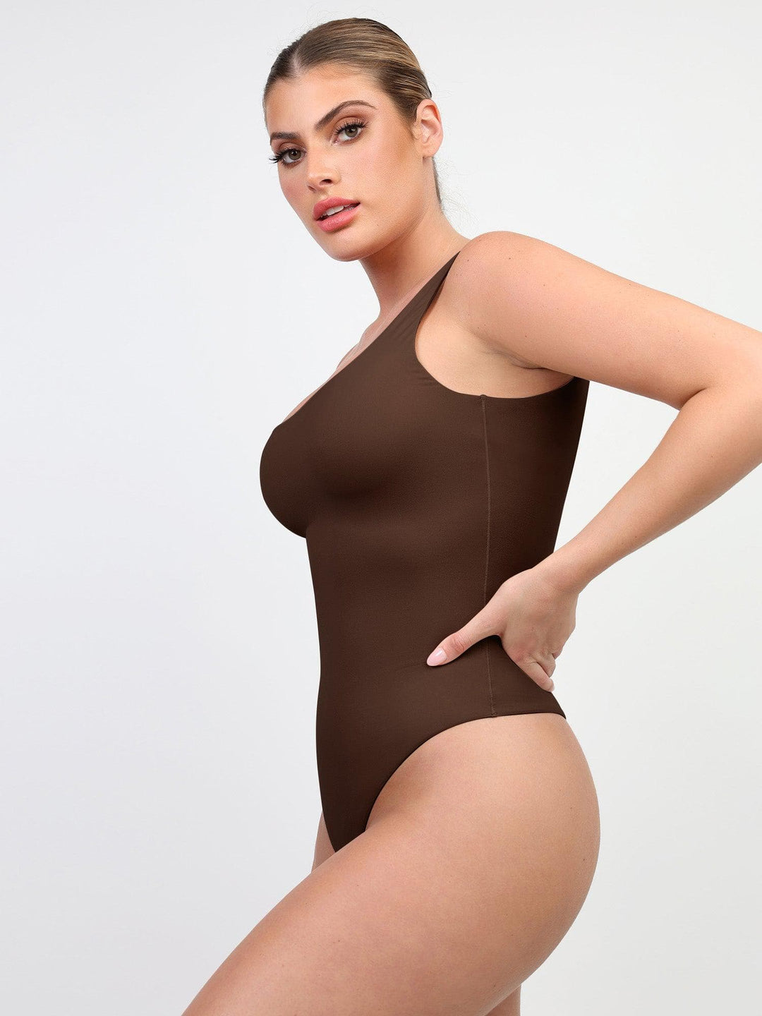 Brown high-cut bodysuit featuring a deep square neckline on a model by Popilush® .