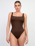 Brown high-cut thong bodysuit with deep square neckline on model by Popilush® .