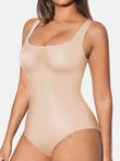 Beige seamless smoothing shapewear tank bodysuit with scoop neckline.