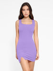 Popilush® model wearing a lavender mini tank dress with a side slit