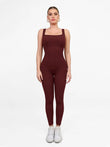 Seamless burgundy square neck shapewear jumpsuit enhancing butt lift and body shape.