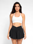 Black workout shapewear shorts with V-waistband for tummy control, white sports bra.