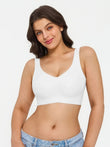 White wireless push-up bra with wide straps on a woman with long brown hair, showing supportive lift and comfort.